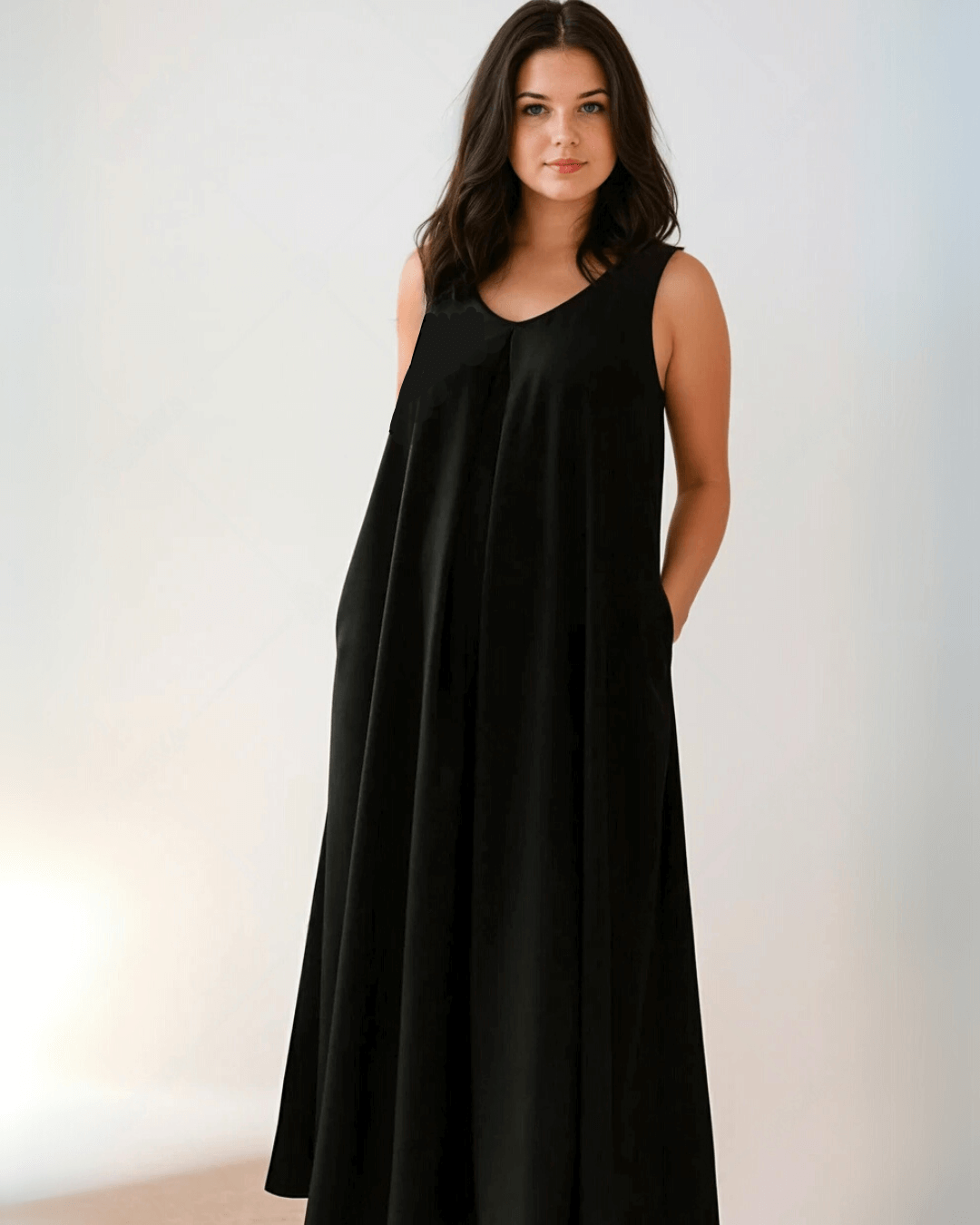 stylish pregnancy maternity brand for women with money and senior jobs in London, Dublin, NYC, a long black dress that hides or disguises a pregnancy with a v-neck and in beautiful premium black fabric