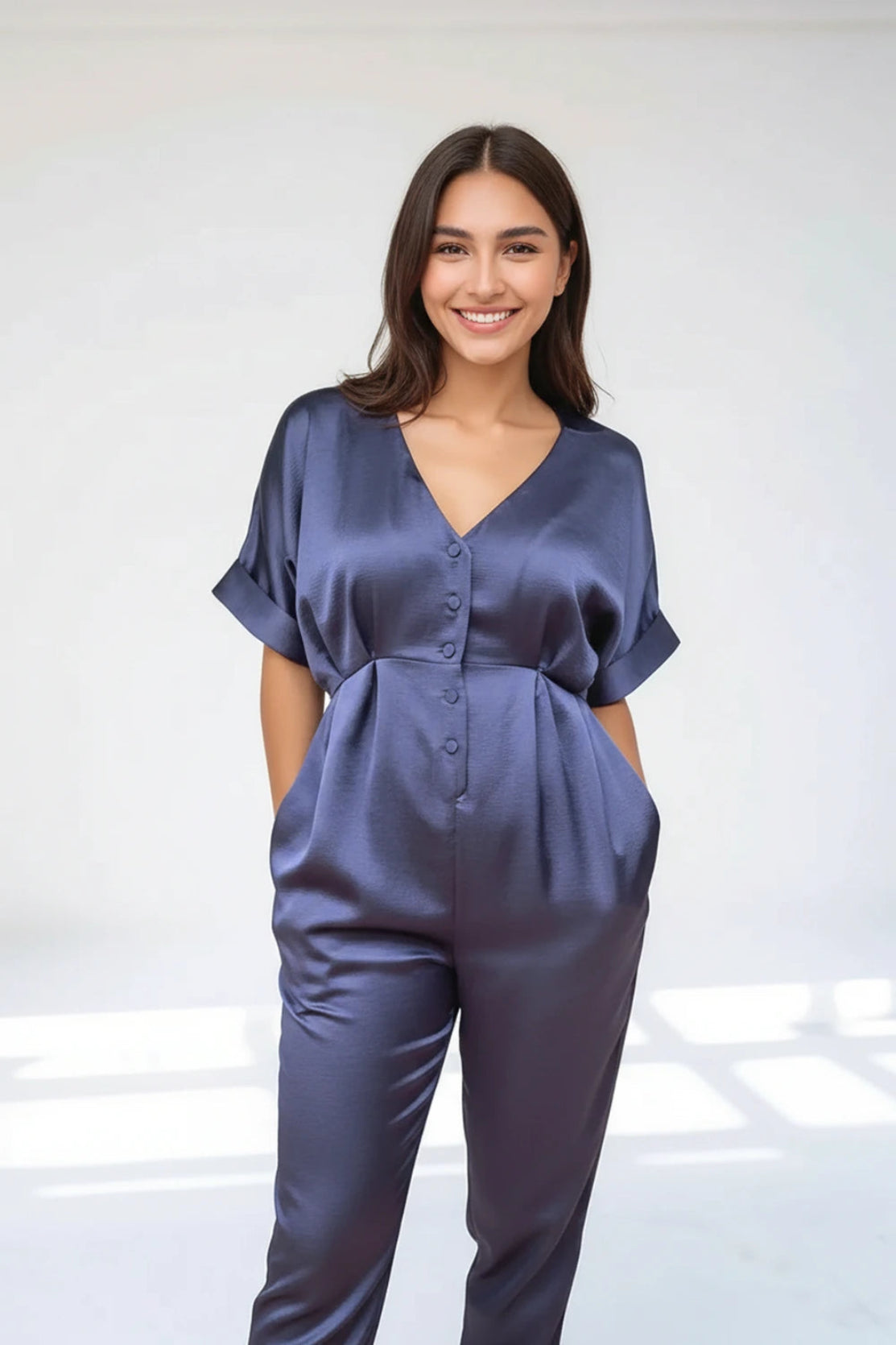 Breastfeeding new mother in nursing friendly navy satin jumpsuit style that is flattering for postpartum - CARI is a contemporary designer brand for pregnancy & motherhood