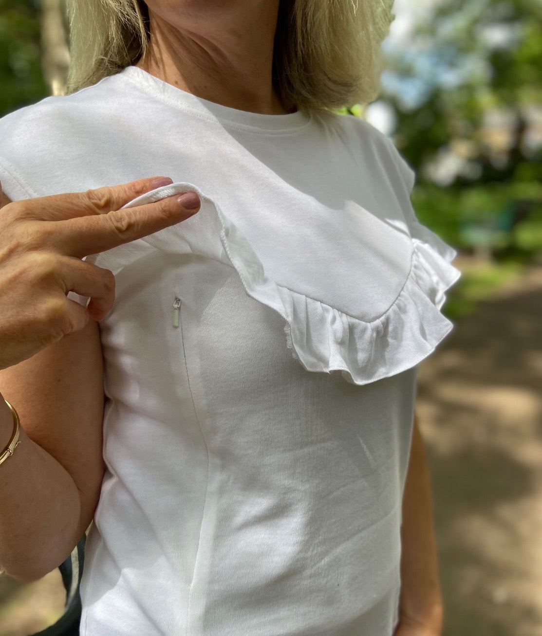 Breastfeeding top. Effortless everyday style and comfort with this white breastfeeding t-shirt. Designed for stress-free nursing on-the-go. Hidden zips sit under the ruffle, easily done one-handed makes it the perfect everyday top for new mums, and a must-have for your breastfeeding wardrobe.