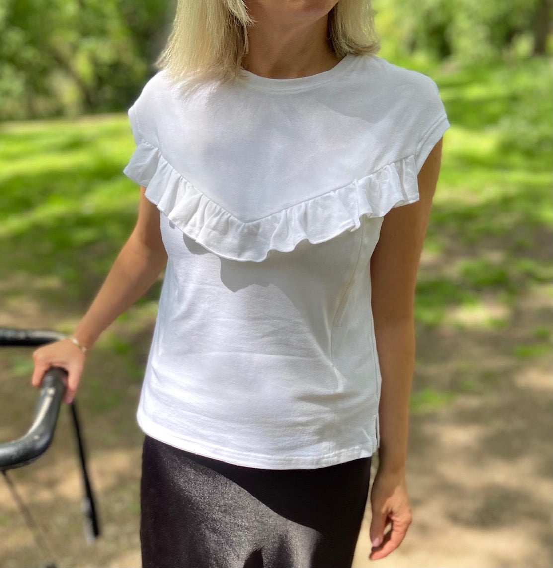 Breastfeeding top. Effortless everyday style and comfort with this white breastfeeding t-shirt. Designed for stress-free nursing on-the-go. Hidden zips sit under the ruffle, easily done one-handed makes it the perfect everyday top for new mums, and a must-have for your breastfeeding wardrobe.
