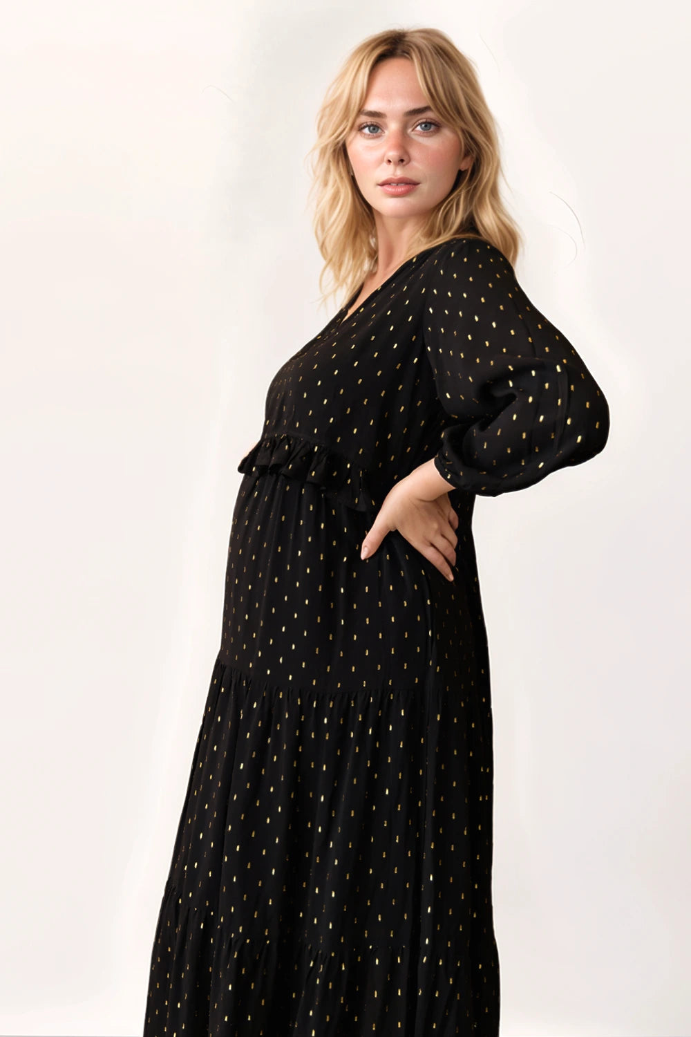 Pregnant woman in boho style flowy black autumn winter dress with v-neck - Stylish maternity fashion brand for pregnancy 