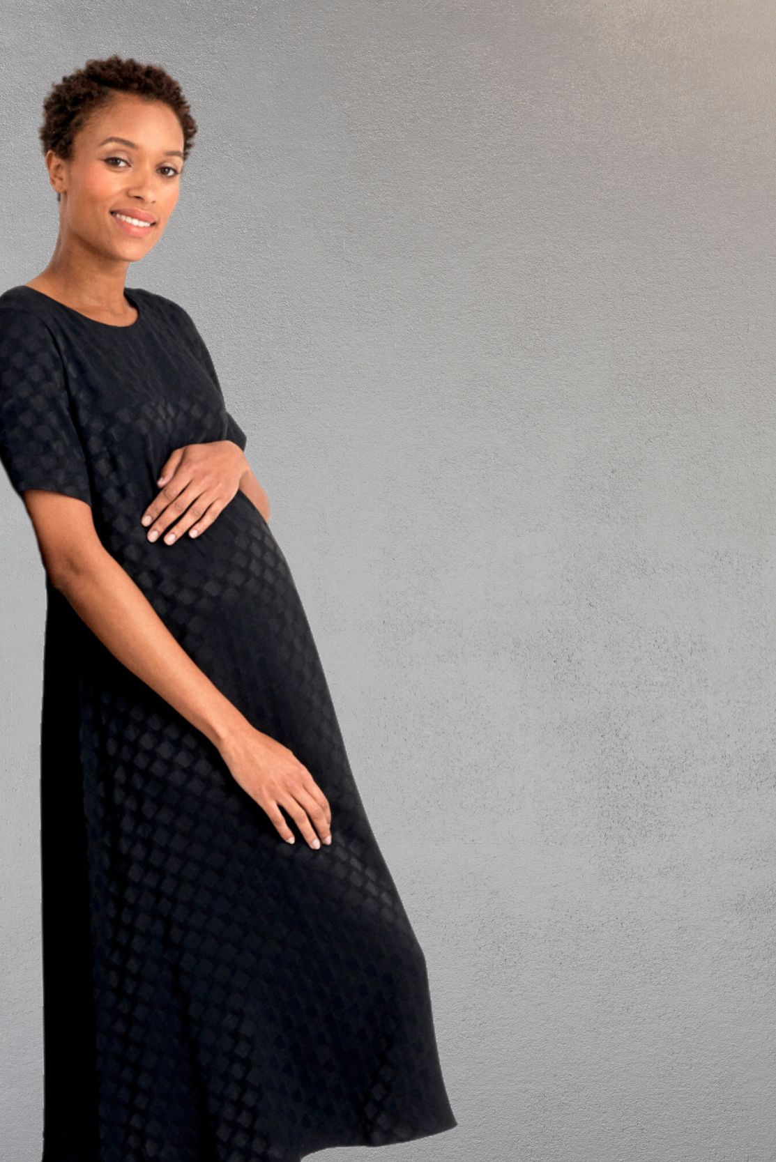 Elevated, premium quality luxury dress for pregnant professionals, in a trapeze style that is not slim-fit so is suitable for the office