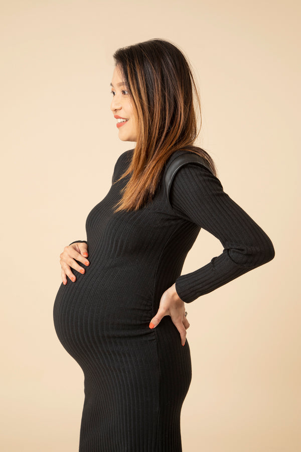 This maternity dress is a must-have 'Little Black Dress' for every stylish maternity wardrobe. Made in skin-soft fabric that hugs your growing curves in all the right places. Discreet ruching gives the ‘perfect fit’ bump silhouette. The ideal modern maternity office wear dress that will take you from day to evening.