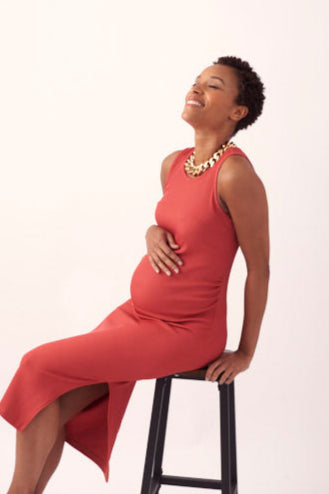 A maternity dress for going out and having fun in gorgeous terracotta raspberry tone. Designed to flatter the pregnant silhouette, and made in a luxurious, lightweight, ribbed Italian slinky fabric that feels soft against your skin while keeping you cool. An essential for the summer maternity wardrobe.