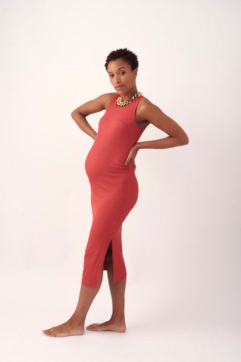 A maternity dress for going out and having fun in gorgeous terracotta raspberry tone. Designed to flatter the pregnant silhouette, and made in a luxurious, lightweight, ribbed Italian slinky fabric that feels soft against your skin while keeping you cool. An essential for the summer maternity wardrobe.