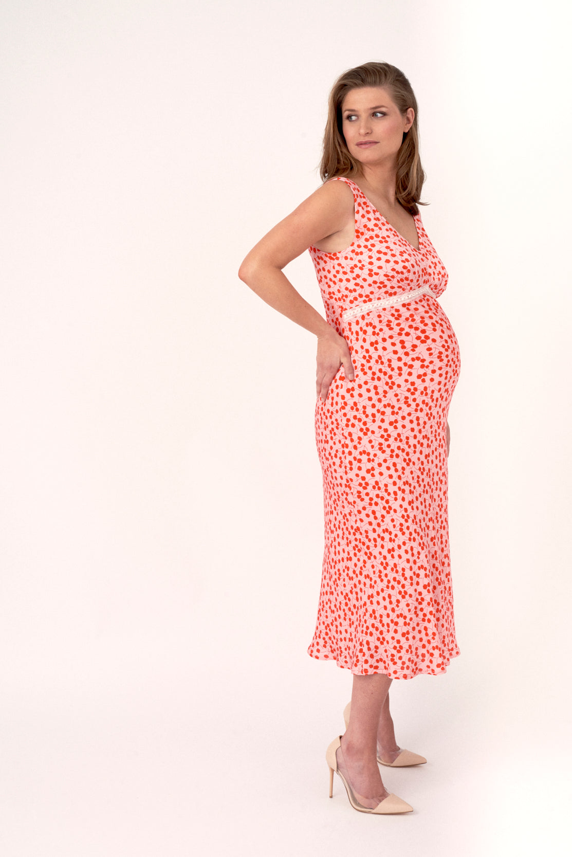 Pretty in pink in this beautiful pink and red sateen maternity dress. Elegant and luxe, this is the perfect elevated maternity occasion dress for weddings, parties and evening events. Designed to accommodate a 9-month bump but it is also very flattering dress for post pregnancy as it drapes the body.